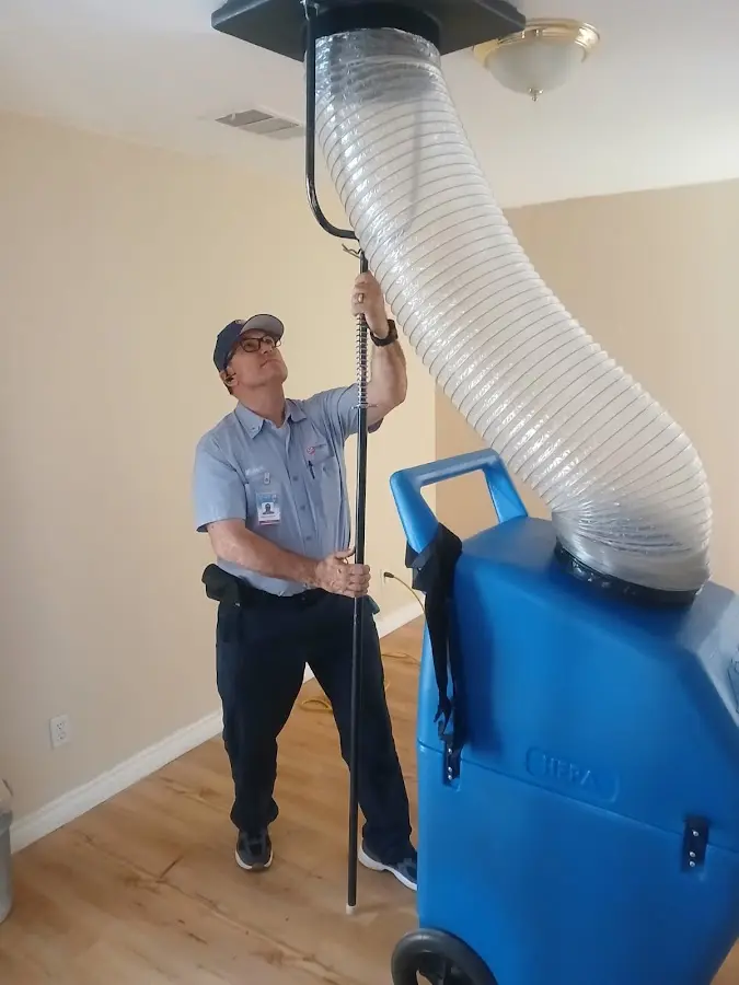 Furnace Tune-Up technician using HEPA equipment in St. Augustine Beach