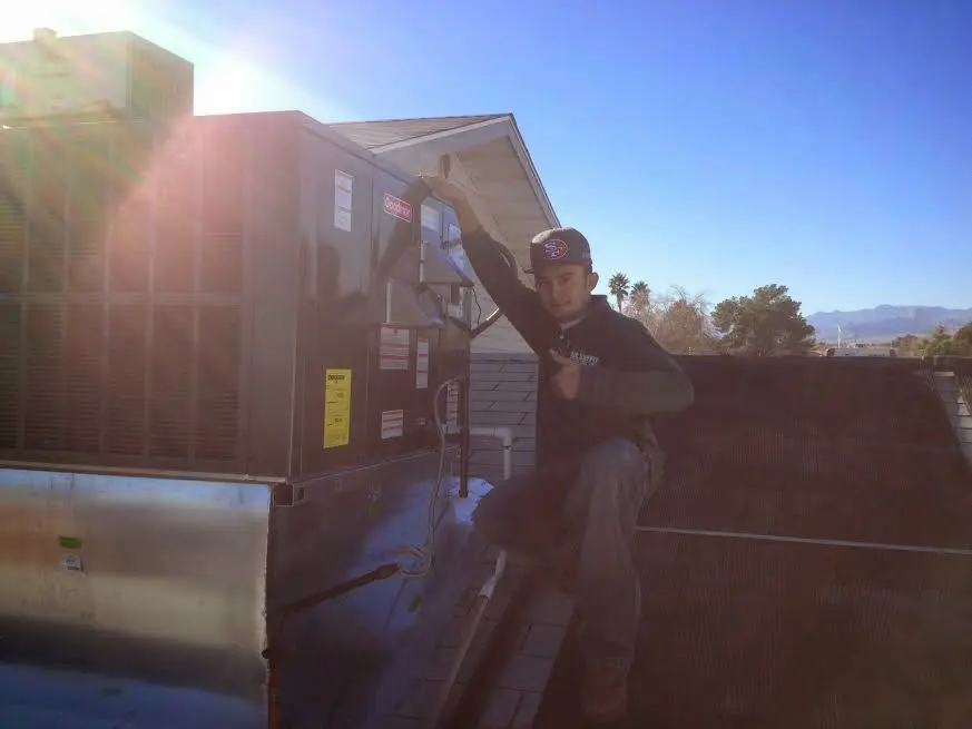 HVAC technician performing HVAC Inspection on a rooftop unit in St. Augustine Beach